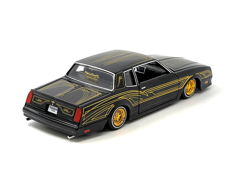 1986 Chevrolet Monte Carlo SS Lowrider Black Metallic with Gold Graphics and Wheels "Lowriders" Series 1/24 Diecast Model Car by Maisto