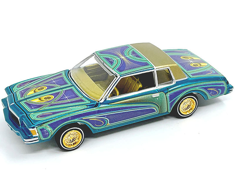 1978 Chevrolet Monte Carlo Lowrider Blue Metallic with Graphics and Gold Metallic Interior with Diecast Figure Limited Edition to 3600 pieces Worldwide 1/64 Diecast Model Car by Johnny Lightning